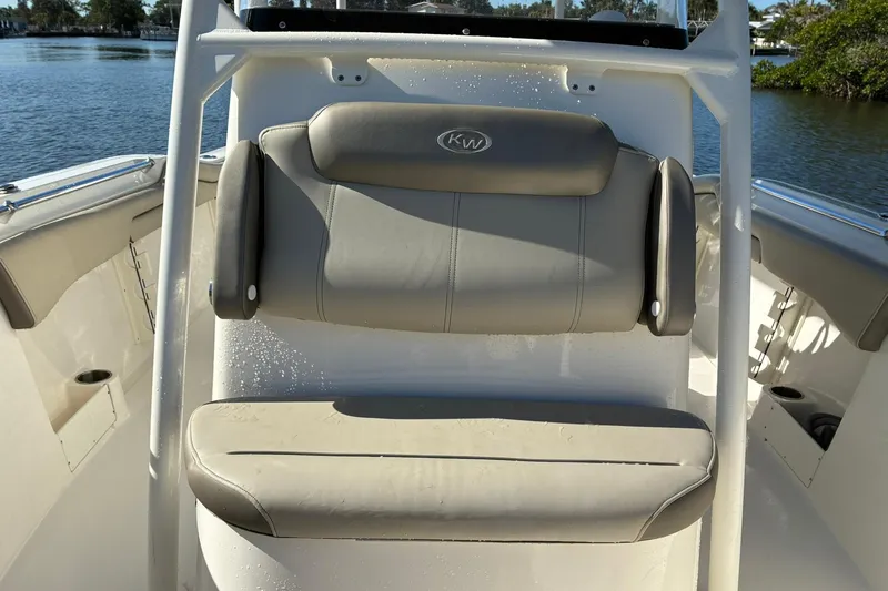 Slide: The Image of 2022 Key West 263 FS boat seat with gray cushions, on a sunny day by the water. - 17