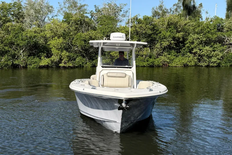 Slide: The Image of 2022 Key West 263 FS boat on calm water, surrounded by lush greenery. - 3