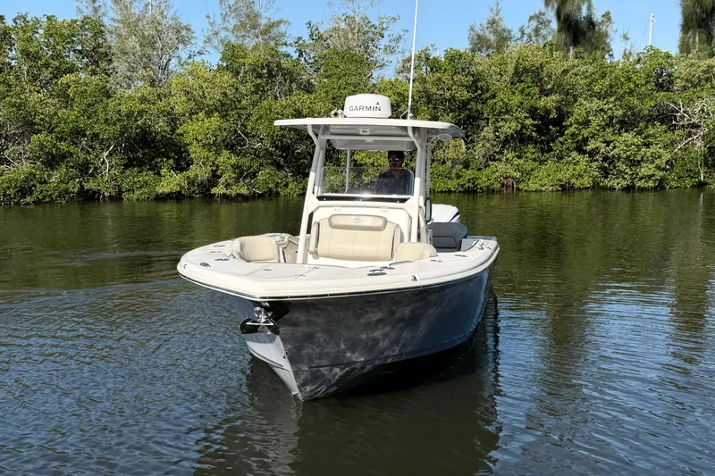 Slide: The Image of 2022 Key West 263 FS boat on calm water, surrounded by lush greenery. - 4
