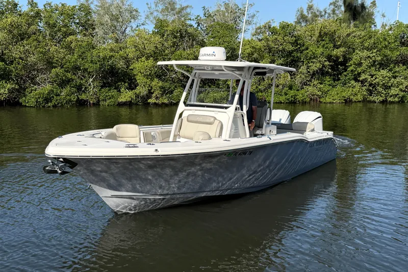 Slide: The Image of 2022 Key West 263 FS boat on calm water, surrounded by lush greenery. - 5