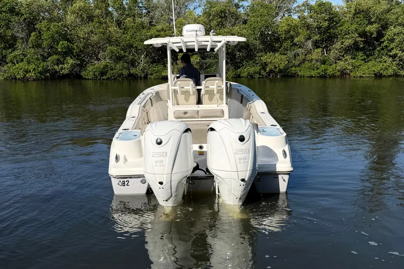 Slide: The Image of 2022 Key West 263 FS boat with dual engines on calm water. - 7