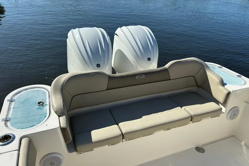 Slide: The Image of 2022 Key West 263 FS boat with dual engines and comfortable seating on calm water. - 8