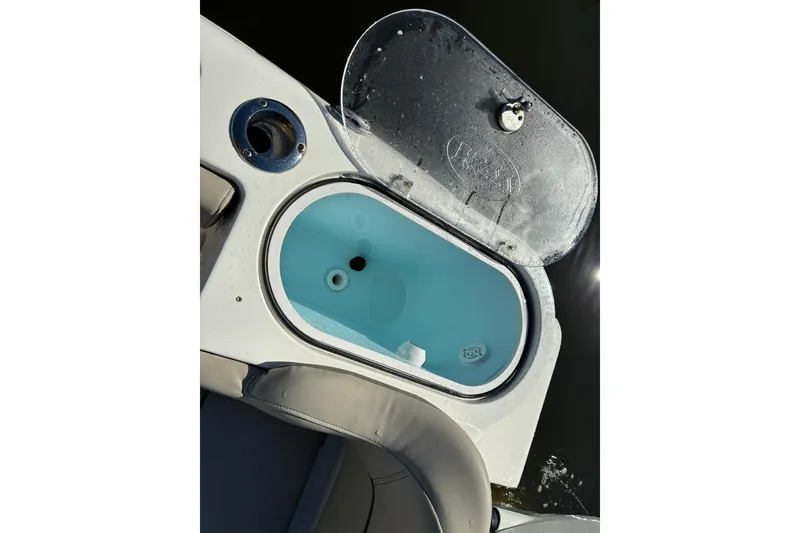 Slide: The Image of Livewell on 2022 Key West 263 FS boat, open lid, blue interior. - 9