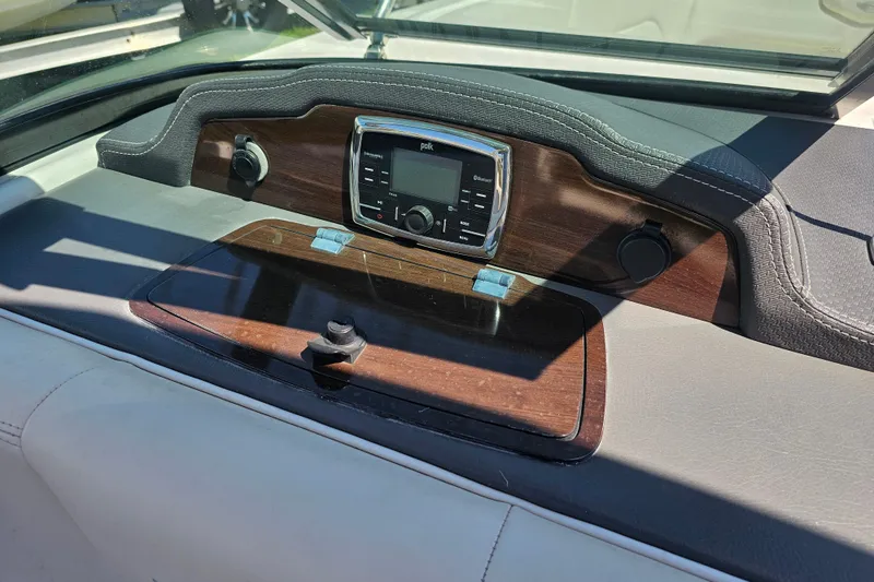Slide: The Image of Dashboard of 2017 Chaparral 227 SSX boat with audio controls and wood finish. - 17