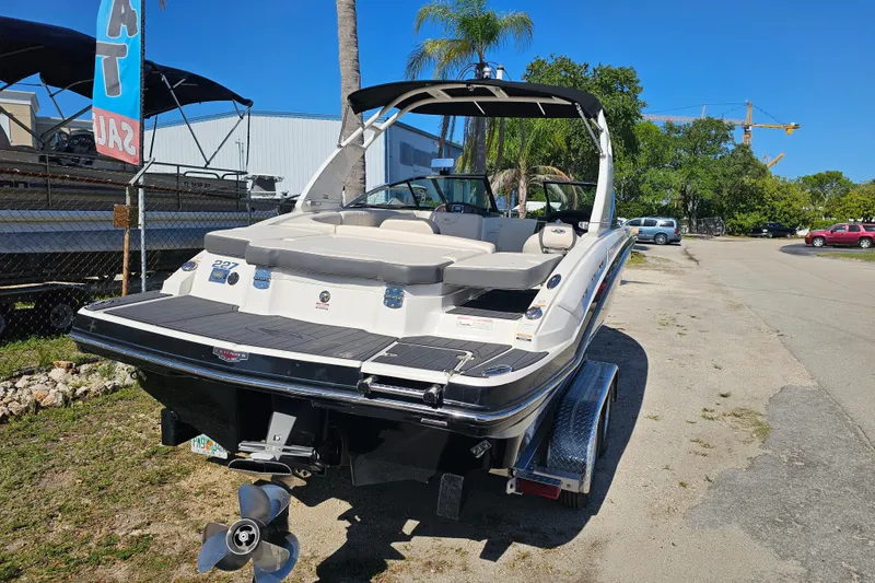 Slide: The Image of 2017 Chaparral 227 SSX boat on trailer, parked outdoors under clear blue sky. - 5