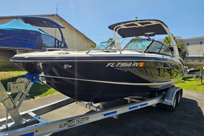Slide: The Image of 2017 Chaparral 227 SSX boat on trailer, parked outdoors under clear sky. - 8