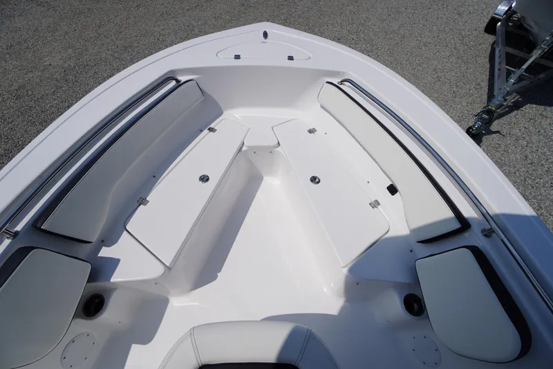 Slide: The Image of 2026 Tidewater 198 CC Adventure boat interior with white seating and storage compartments. - 11