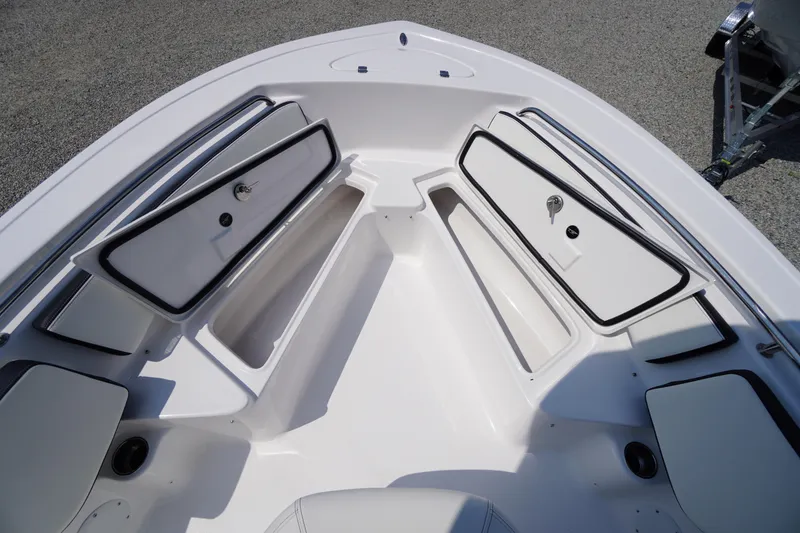 Slide: The Image of 2026 Tidewater 198 CC Adventure boat with open storage compartments on deck. - 12