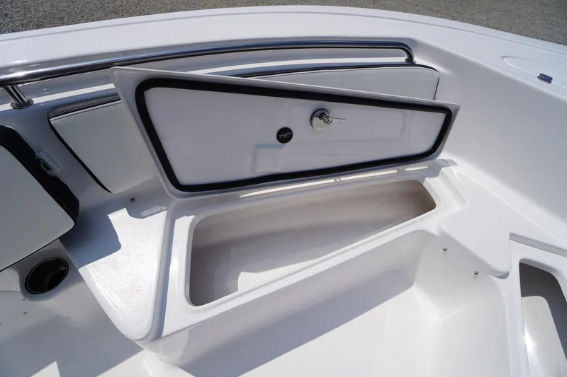 Slide: The Image of 2026 Tidewater 198 CC Adventure boat storage compartment with open hatch and key lock. - 13