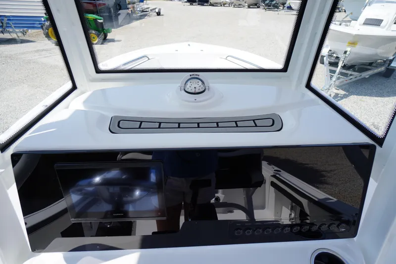 Slide: The Image of 2026 Tidewater 198 CC Adventure boat dashboard with compass and navigation screen. - 21