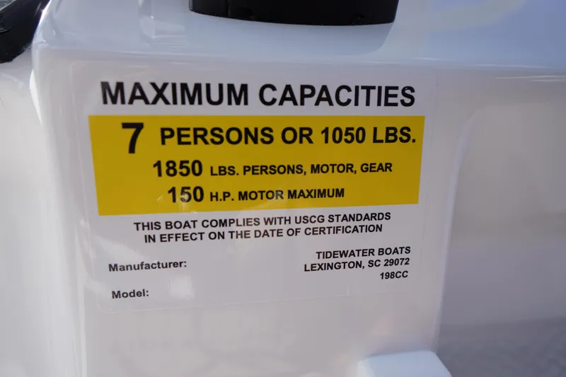 Slide: The Image of 2026 Tidewater 198 CC Adventure boat capacity label, 7 persons or 1050 lbs, 150 HP motor. - 23