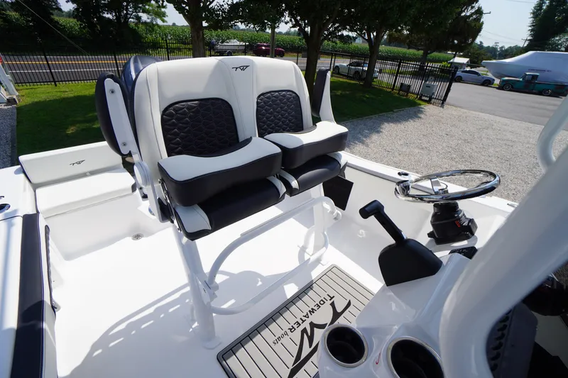 Slide: The Image of 2026 Tidewater 198 CC Adventure boat interior with dual seats and steering console. - 28