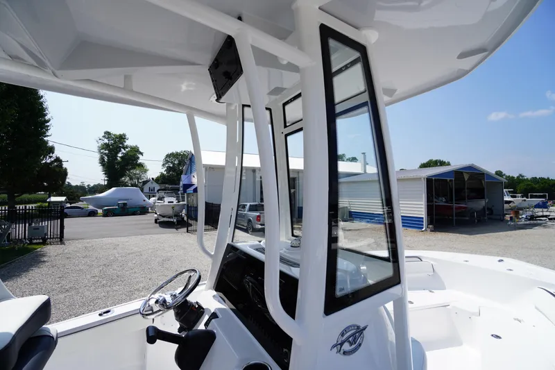 Slide: The Image of 2026 Tidewater 198 CC Adventure boat, featuring sleek design and modern console, docked outdoors. - 30
