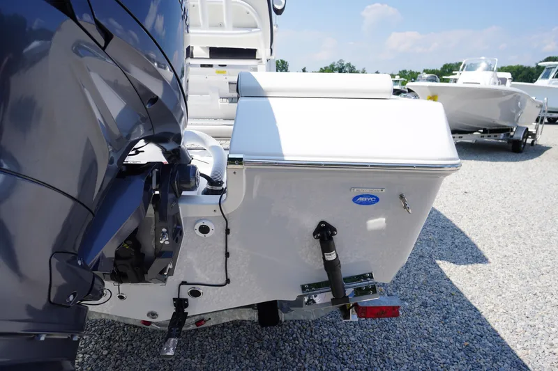 Slide: The Image of 2026 Tidewater 198 CC Adventure boat rear view with motor, parked on gravel. - 47