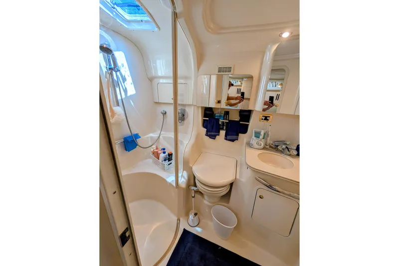 Slide: The Image of Bathroom interior of 2001 Sea Ray 410 Sundancer yacht, featuring shower and vanity. - 14