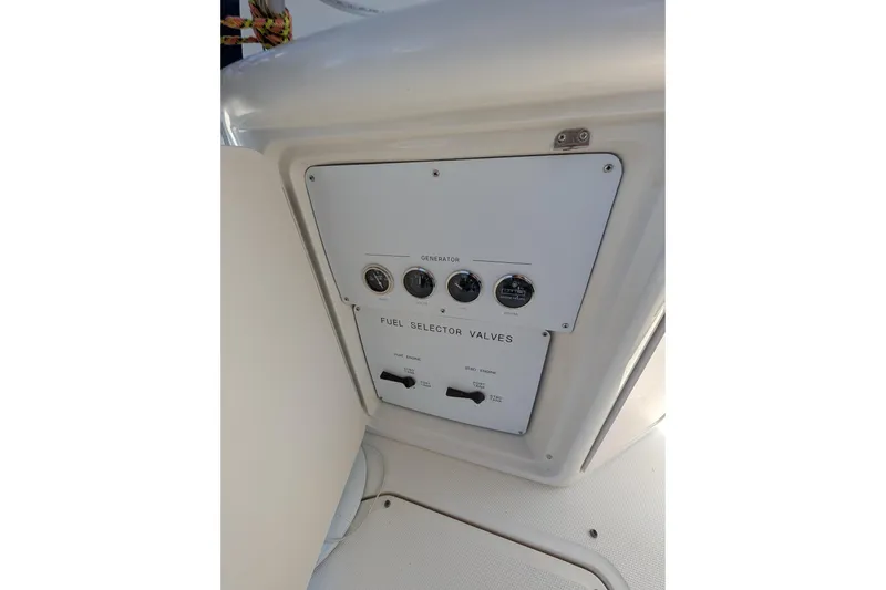 Slide: The Image of Control panel of a 2001 Sea Ray 410 Sundancer with fuel selector valves. - 25