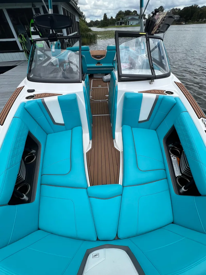 Slide: The Image of 2018 Nautique Super Air G23 with turquoise seating and sleek design on a calm lake. - 4