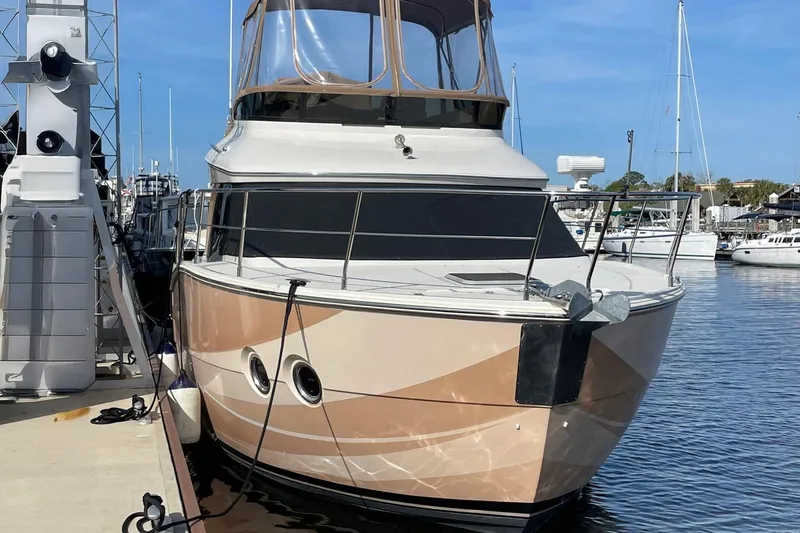 Slide: The Image of 2013 Carver C34 yacht docked at marina under clear blue sky. - 19