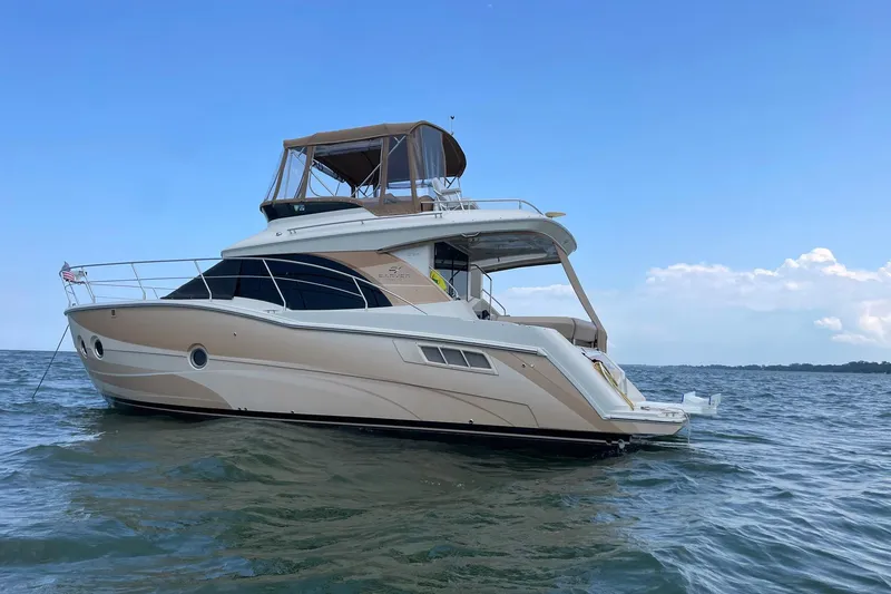 Slide: The Image of 2013 Carver C34 yacht on open water under clear blue sky. - 3