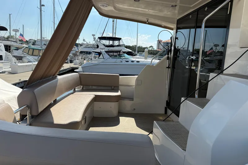 Slide: The Image of 2013 Carver C34 yacht interior with seating area and marina view. - 30