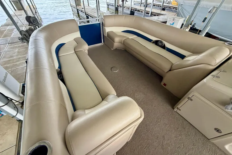 Slide: The Image of Interior of a 2013 Harris Solstice 240 pontoon boat with beige seating. - 11