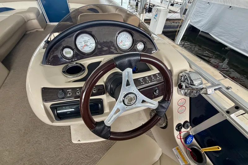 Slide: The Image of Steering console of a 2013 Harris Solstice 240 boat with gauges and controls. - 13