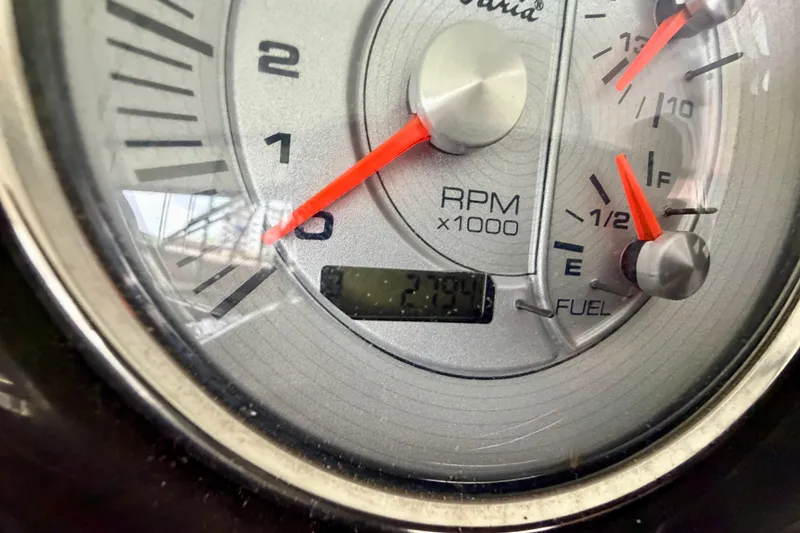 Slide: The Image of Close-up of 2013 Harris Solstice 240 dashboard showing RPM and fuel gauges. - 14