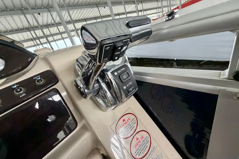 Slide: The Image of Control panel of a 2013 Harris Solstice 240 boat, featuring throttle and trim controls. - 15