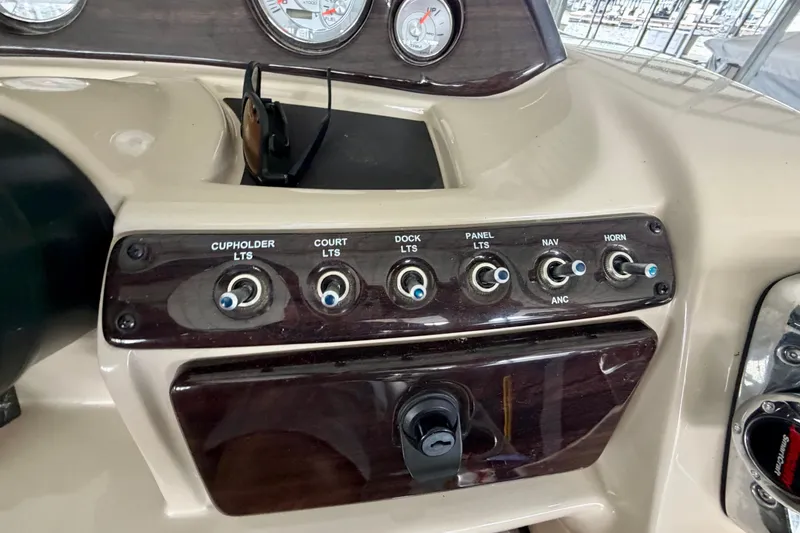 Slide: The Image of Control panel of a 2013 Harris Solstice 240 boat with labeled switches and gauges. - 16