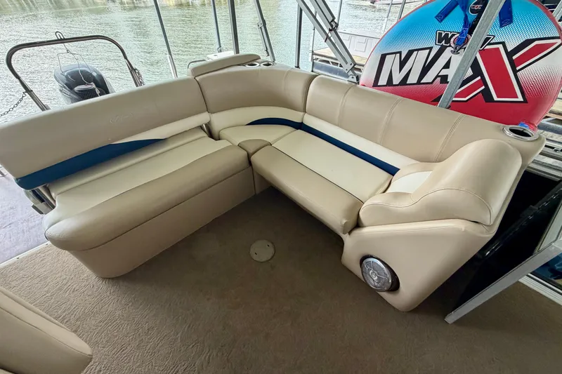 Slide: The Image of Luxurious seating on 2013 Harris Solstice 240 boat with beige upholstery and blue accents. - 18