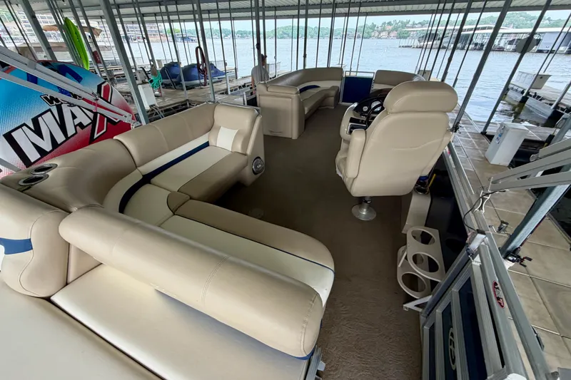 Slide: The Image of Luxurious interior of a 2013 Harris Solstice 240 pontoon boat docked by the water. - 21