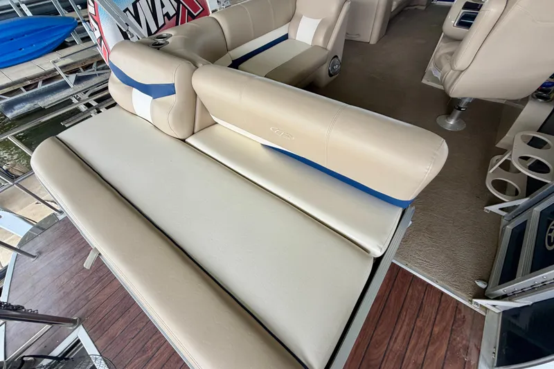 Slide: The Image of 2013 Harris Solstice 240 boat interior with beige seating and wood flooring. - 23