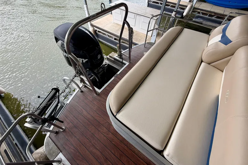 Slide: The Image of 2013 Harris Solstice 240 pontoon boat with outboard motor and cushioned seating. - 25