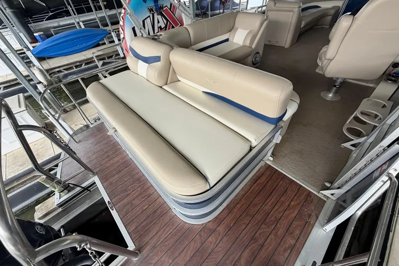 Slide: The Image of Interior of a 2013 Harris Solstice 240 pontoon boat with beige seating and wood flooring. - 26
