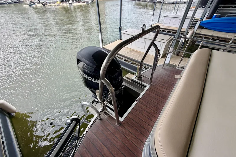 Slide: The Image of 2013 Harris Solstice 240 boat with Mercury outboard motor at dock. - 27