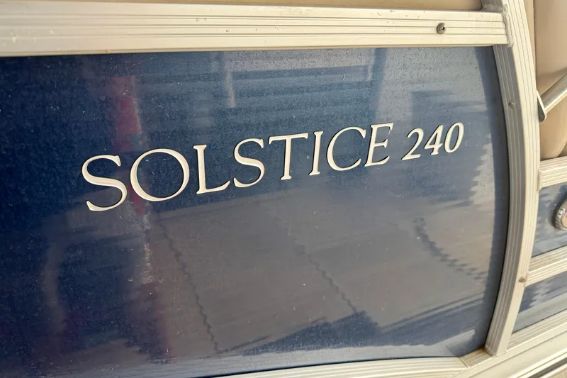 Slide: The Image of 2013 Harris Solstice 240 boat nameplate on blue background. - 30