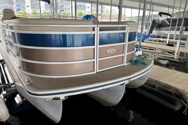 Slide: The Image of 2013 Harris Solstice 240 pontoon boat docked in a marina. - 32