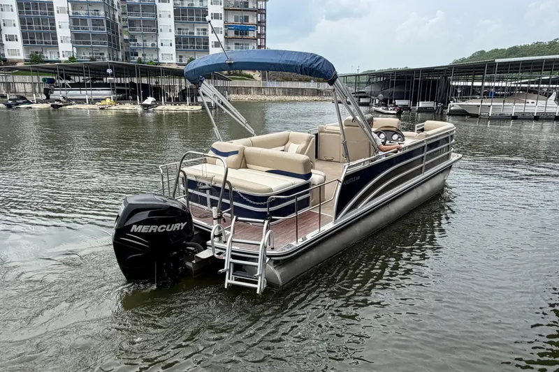 Slide: The Image of 2013 Harris Solstice 240 pontoon boat with Mercury engine on a calm marina. - 4
