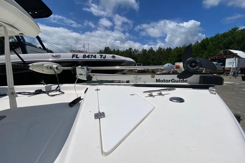 Slide: The Image of 2003 Seapro 1700 CC boat with MotorGuide trolling motor, docked under a partly cloudy sky. - 11