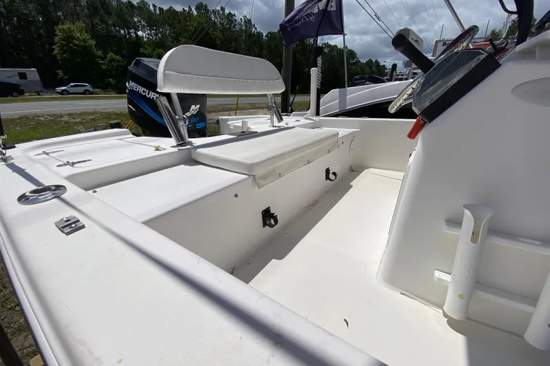 Slide: The Image of 2003 Seapro 1700 CC boat interior with seating and Mercury engine. - 13