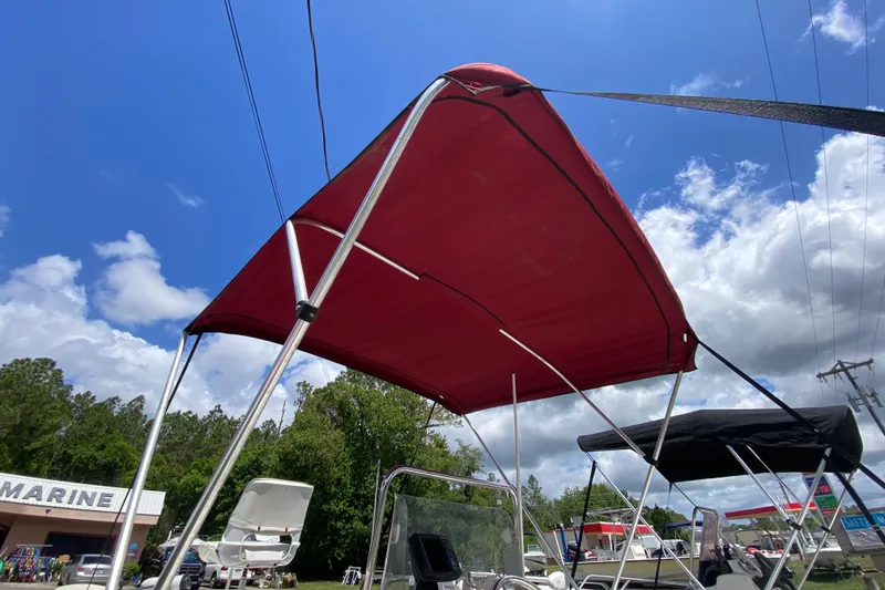 Slide: The Image of Red bimini top on a 2003 Seapro 1700 CC boat under a blue sky. - 7