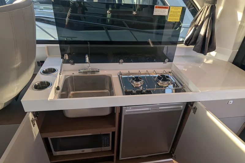Slide: The Image of Modern kitchen area in 2024 Beneteau Antares 11 Fly yacht with stove and sink. - 11