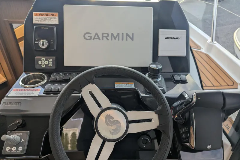 Slide: The Image of Helm of 2024 Beneteau Antares 11 Fly with Garmin navigation and Mercury controls. - 12