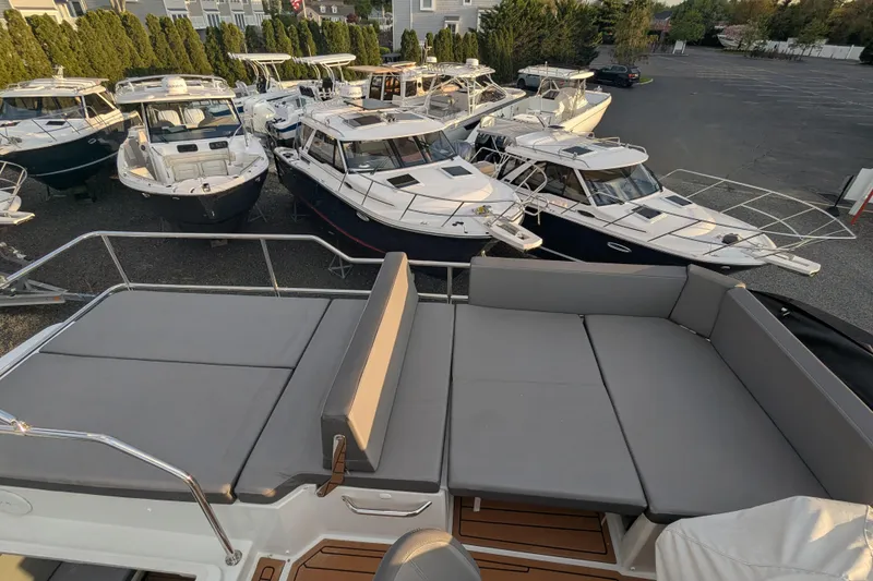 Slide: The Image of 2024 Beneteau Antares 11 Fly yacht with spacious deck, surrounded by other boats. - 24