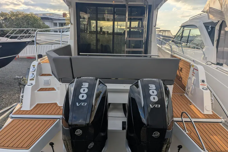 Slide: The Image of 2024 Beneteau Antares 11 Fly with twin Mercury 300 V8 engines, docked at marina. - 4