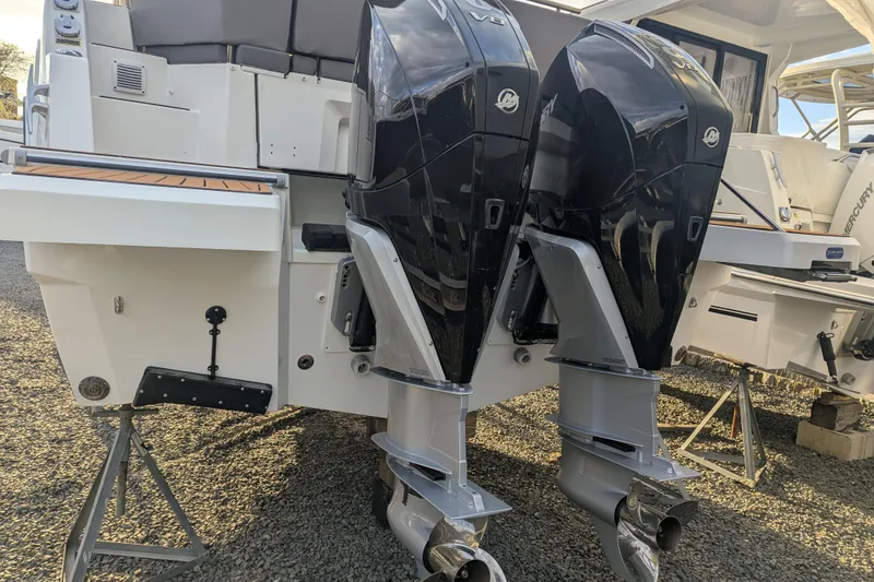 Slide: The Image of 2024 Beneteau Antares 11 Fly with dual Mercury outboard engines, rear view. - 5