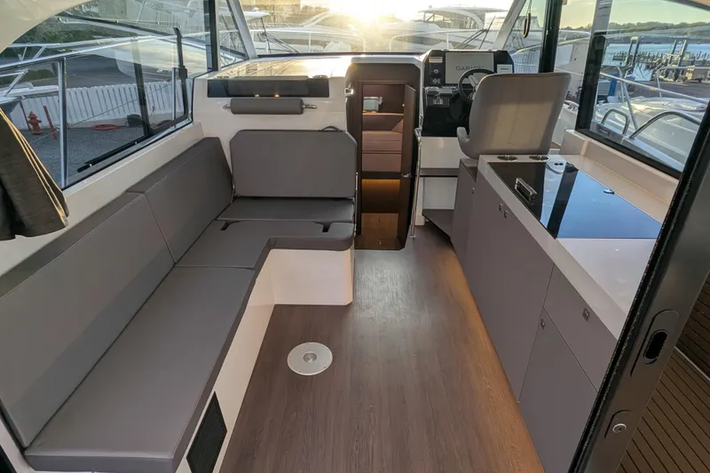 Slide: The Image of Interior of 2024 Beneteau Antares 11 Fly, featuring modern seating and helm station. - 8
