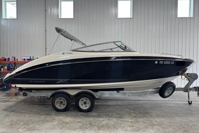 The Image of 2017 Yamaha Boats SX240 HO on trailer in indoor storage facility. - 0