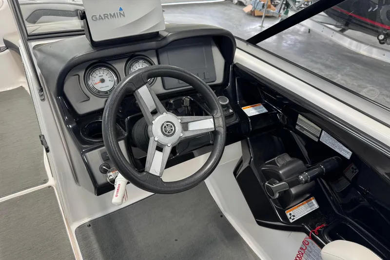 Slide: The Image of 2017 Yamaha Boats SX240 HO dashboard with Garmin GPS and steering wheel. - 7