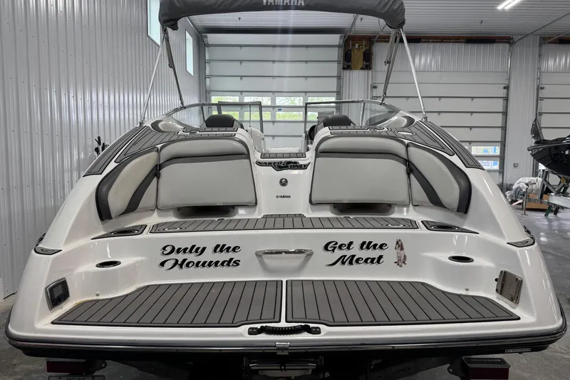 Slide: The Image of 2017 Yamaha SX240 HO boat in garage, featuring custom text on the rear deck. - 8